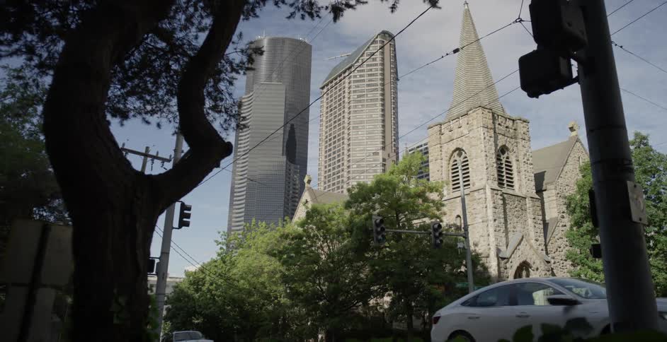 Cars driving past a church in a city