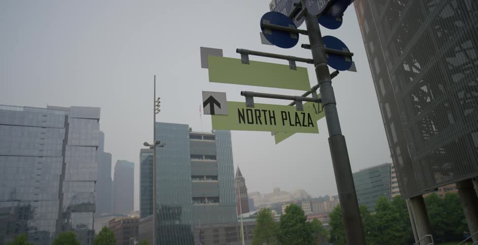 A street sign points toward a downtown area