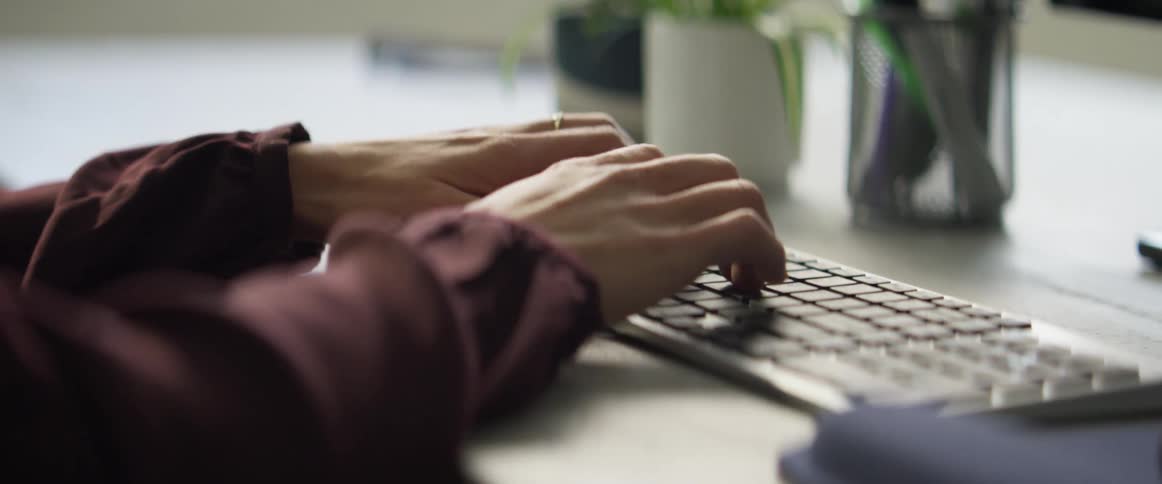 A person is typing on a computer