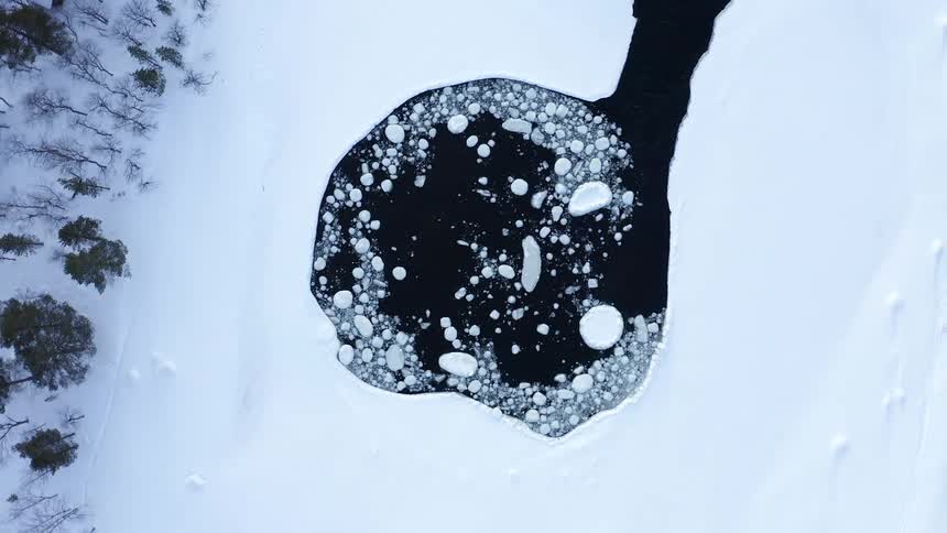 An aerial view of ice floating in an arctic river
