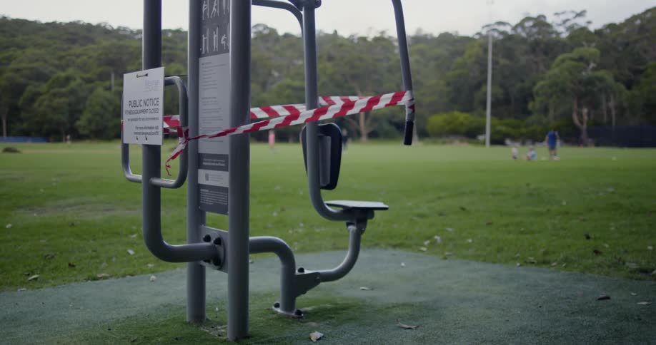 Exercise equipment in the park is closed with caution tape around it