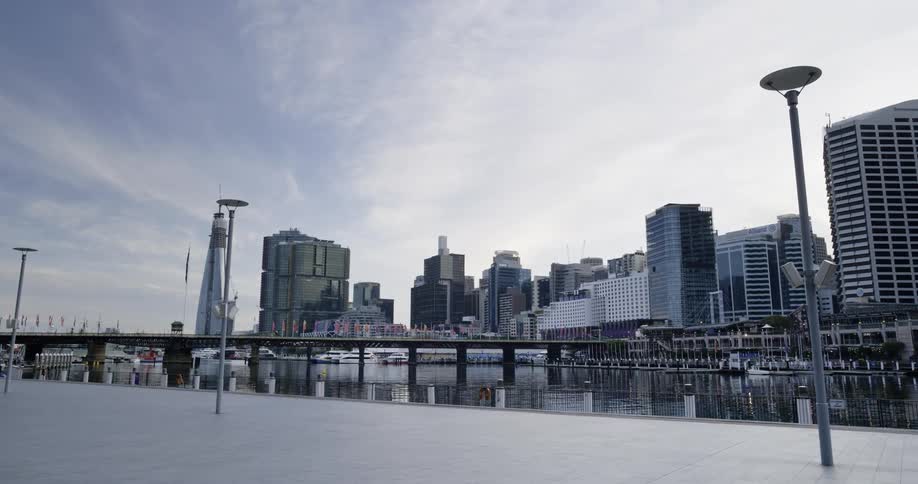 Bicyclist rides along river leading from carnival past bridge across from downtown