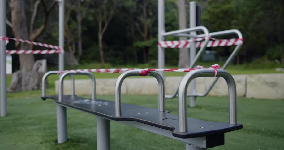 Benches and other public structures in a park closed with security tape