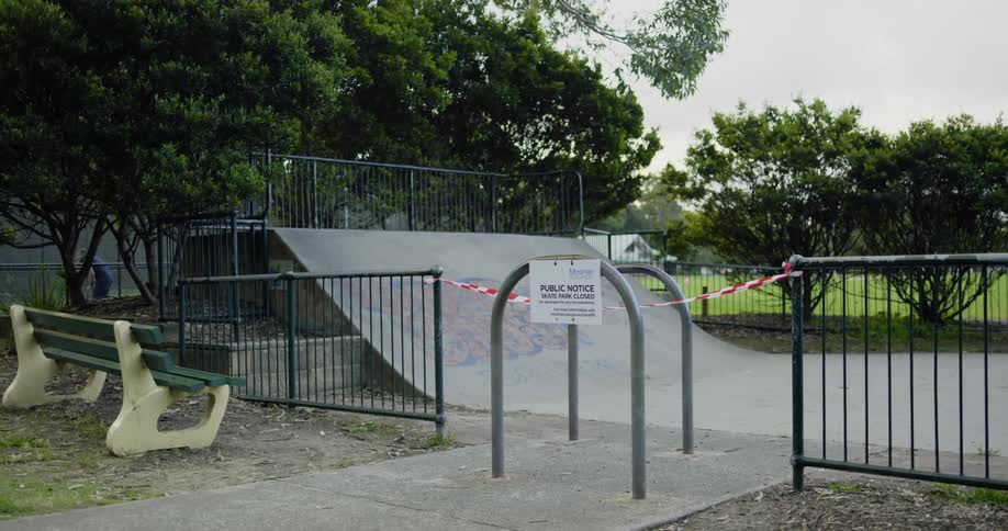 Skate park closed with a security ribbon and a sign on the fence