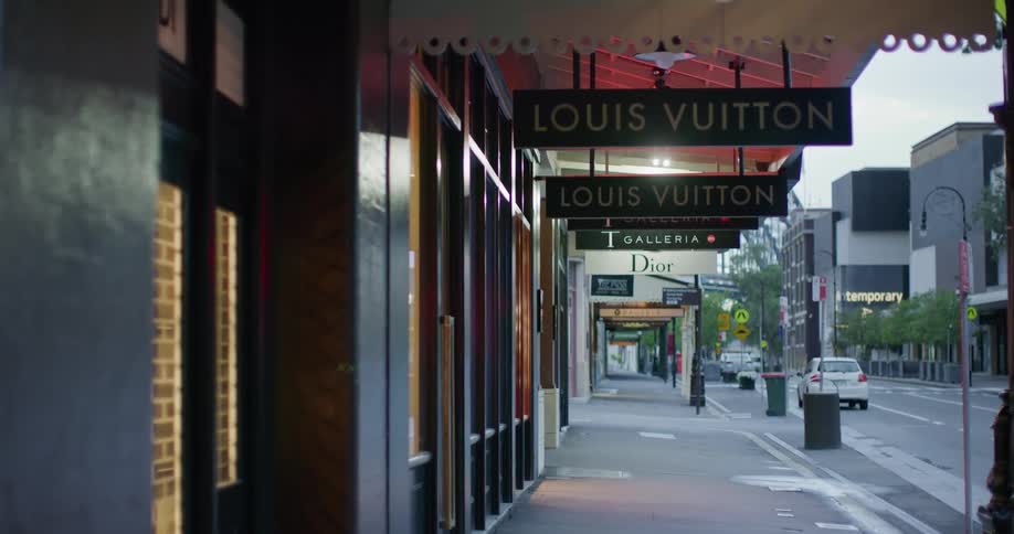 Luxury store sidewalk signage at outdoor mall