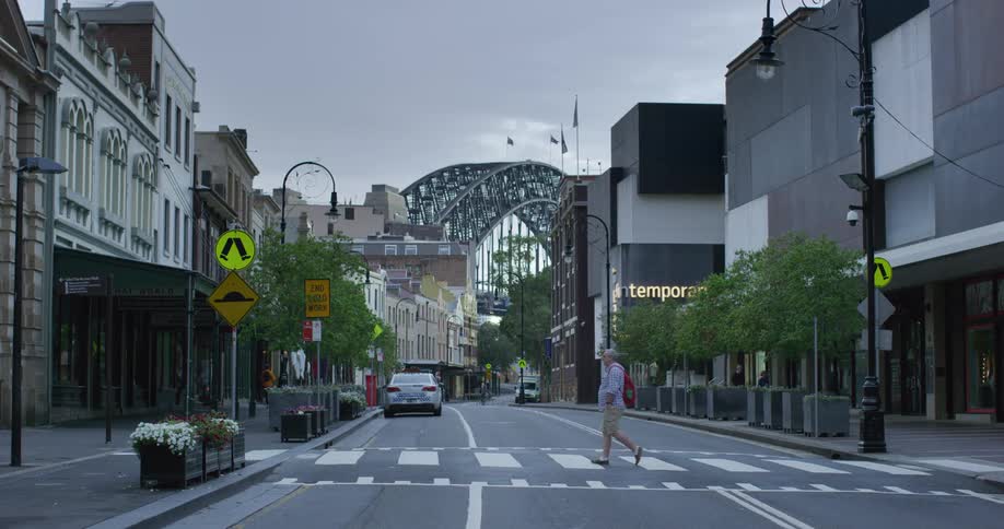 Man crosses the street in a retail area of the city