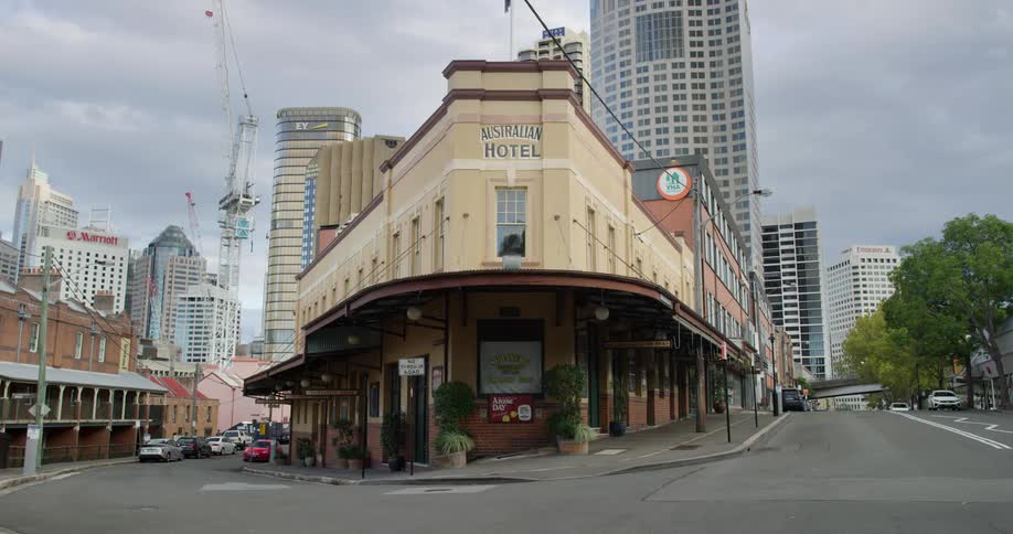 Australian hotel sits next to the city road under a cloudy sky