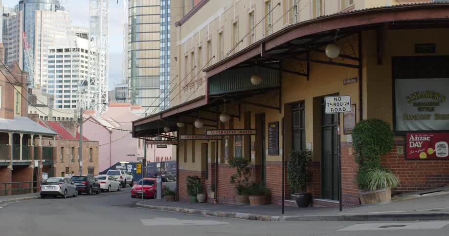 Cars parked in a hotel street in the city next to downtown skyscrapers
