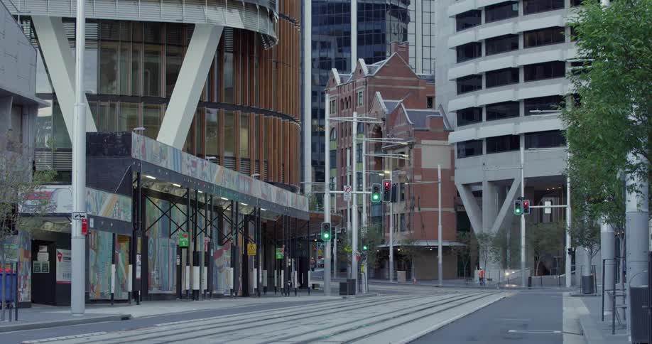 Single pedestrian walks on the empty streets of a city downtown area
