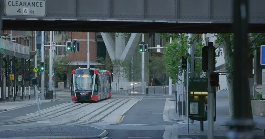A subway driving down a city street