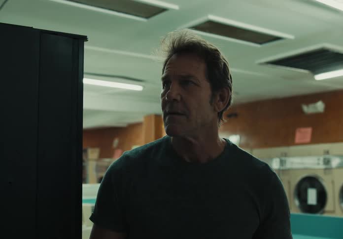 A man looks around the laundromat
