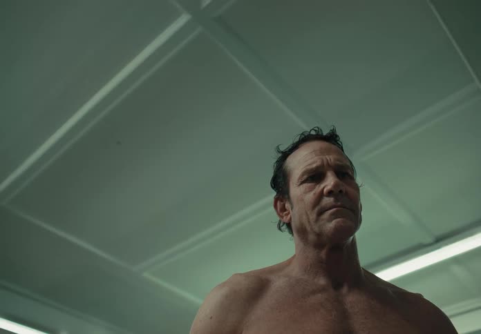 A man stand shirtless and thinking after a shower