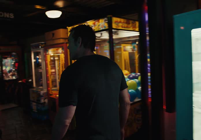 A man walks through an arcade as he heads to a change machine