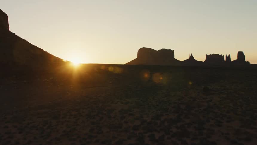 Aerial view of the plains and mesas in the desert badlands at sunset