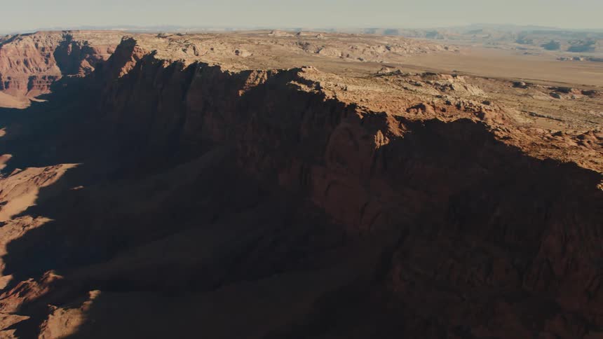 A dry canyon has rocky cliffs