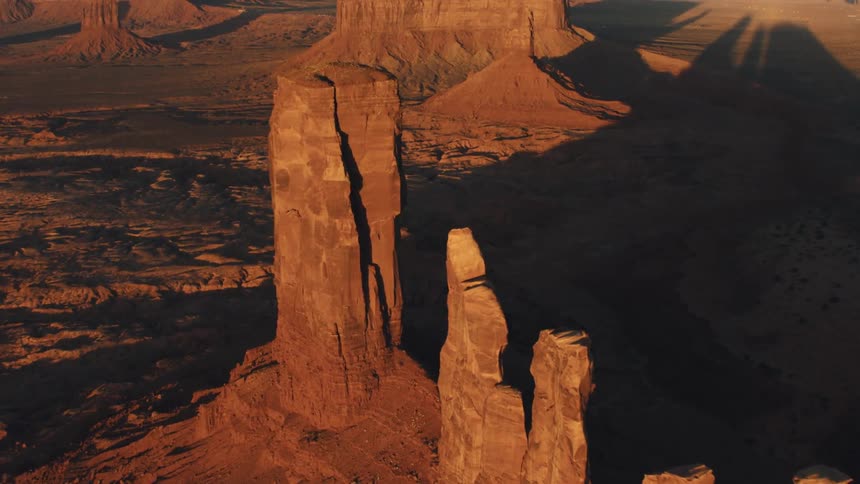 Aerial view of tall thin spire of rock in the badlands desert