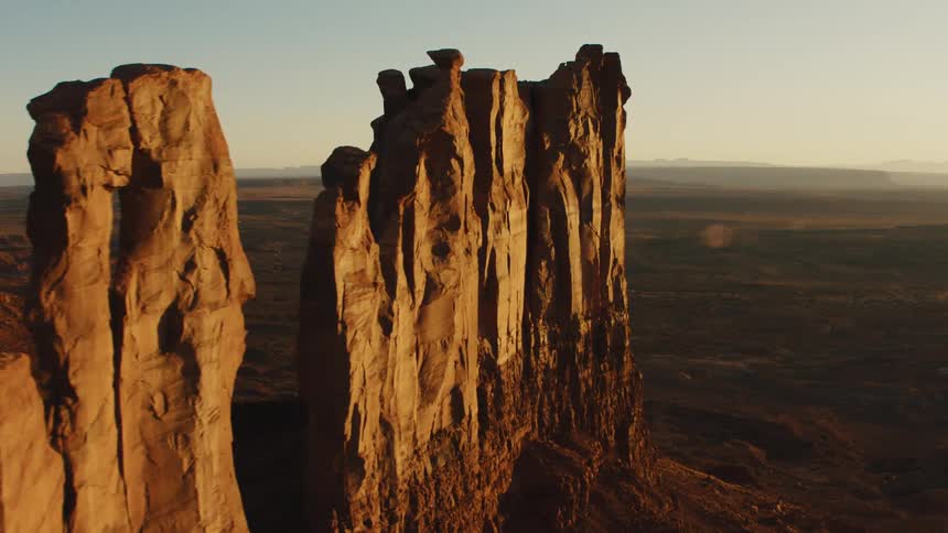 Tall hoodoos in desert at sunrise