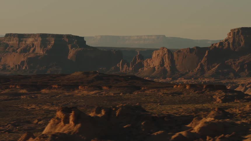 Canyons and mesas on the desert badlands at sunset
