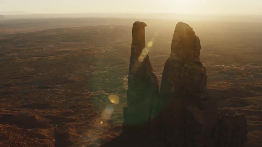 Aerial view of the jagged rocks of the mountains on the desert badlands at sunset