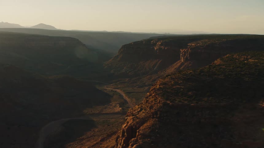 An aerial view of a mountain is displayed at dusk