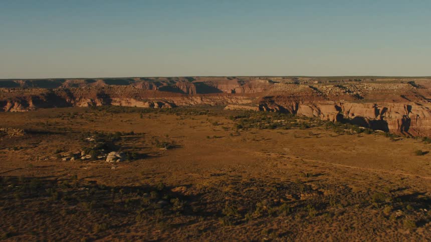The field leads to a cliff on the canyon