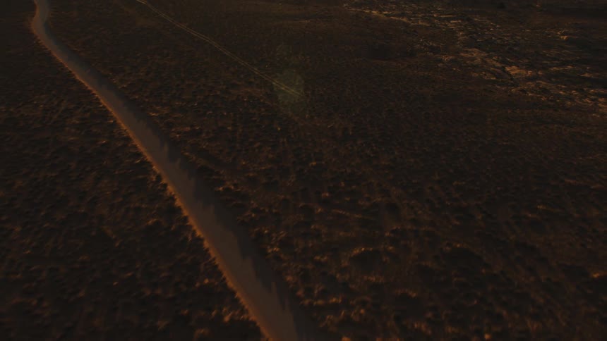 A road winds through a barren area