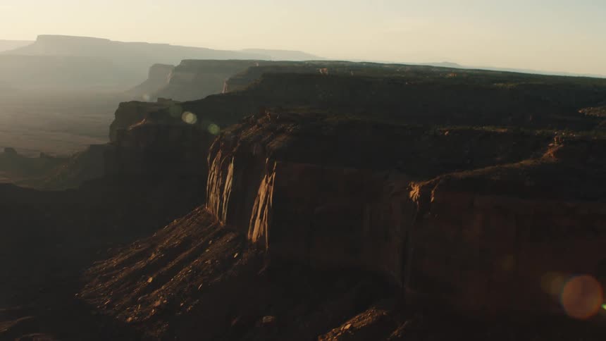 Aerial view of mesas and canyons in the desert badlands at sunset