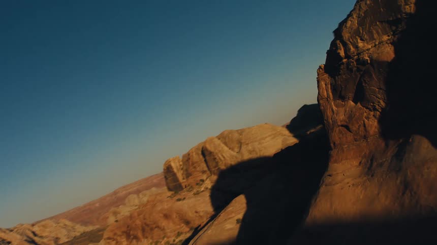 A reflection of a helicopter on a canyon