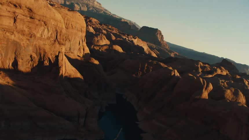 Deep ravines in desert under morning sunlight