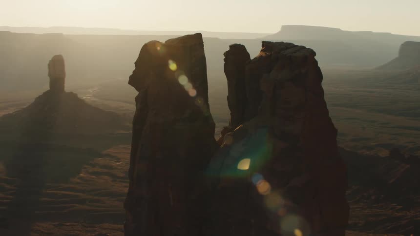 A rock spire towers above a flat rocky area