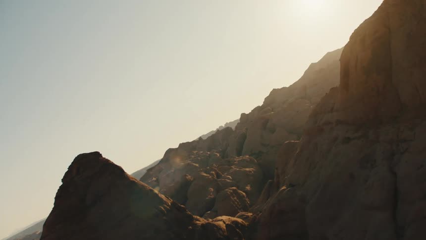 Aerial view of mountains and geological formations on the badlands desert at sunset