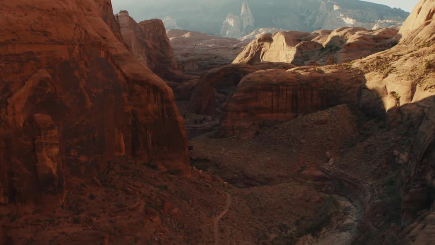 A dried out river runs through the bottom of a canyon