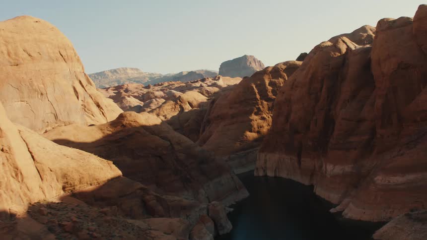 Aerial view of a river in a canyon between mesas in the badlands desert