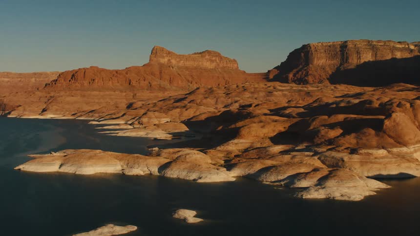 A deep blue lake lies in a rocky area
