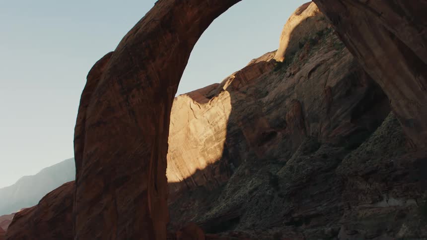 A large arch is in the middle of the canyon