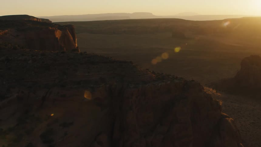 Aerial view of the plains and mesas of the desert badlands at sunset