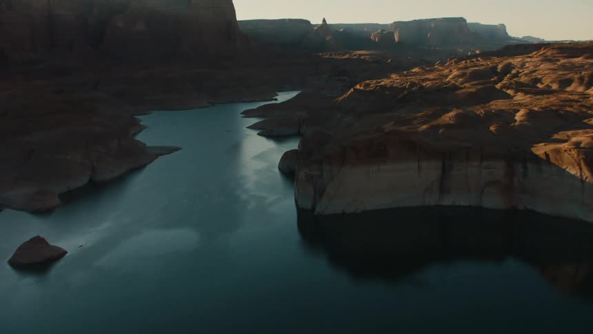 Aerial view of a river with a rocky shore
