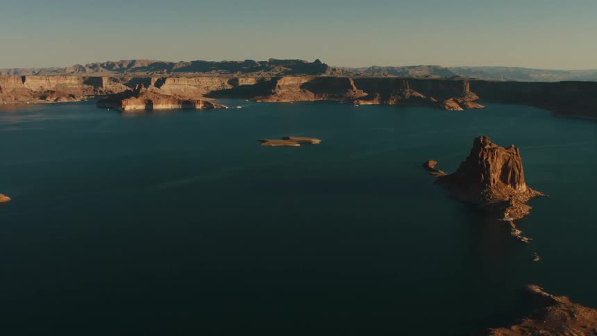 Cliffs and islets border and occupy dark blue water