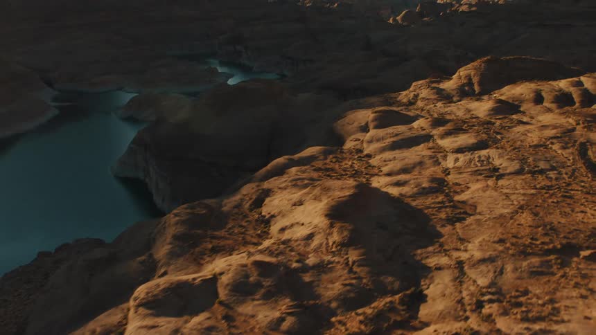 A river curls through the base of a canyon
