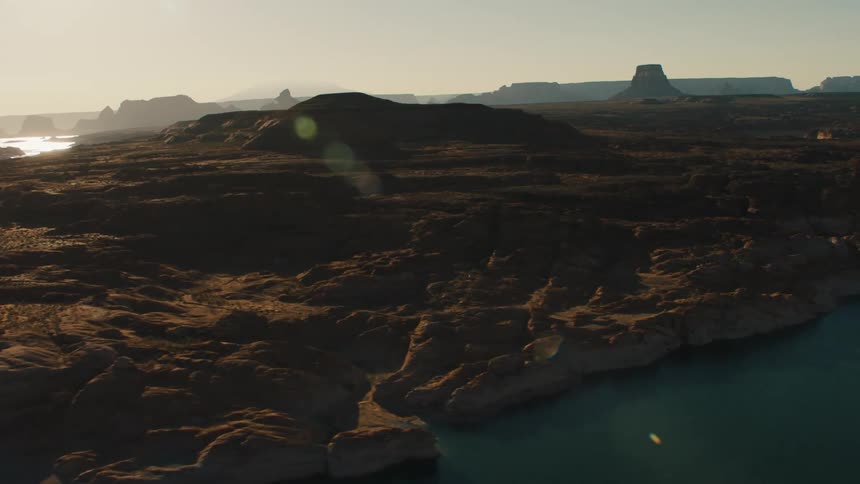 A view of a canyon is displayed at sunset