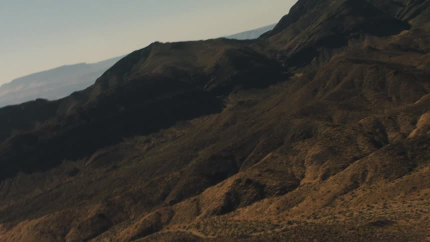 Peaks and valleys of various sizes form a canyon