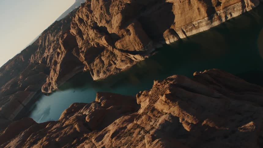 A narrow lake lies betwee rocky cliffs