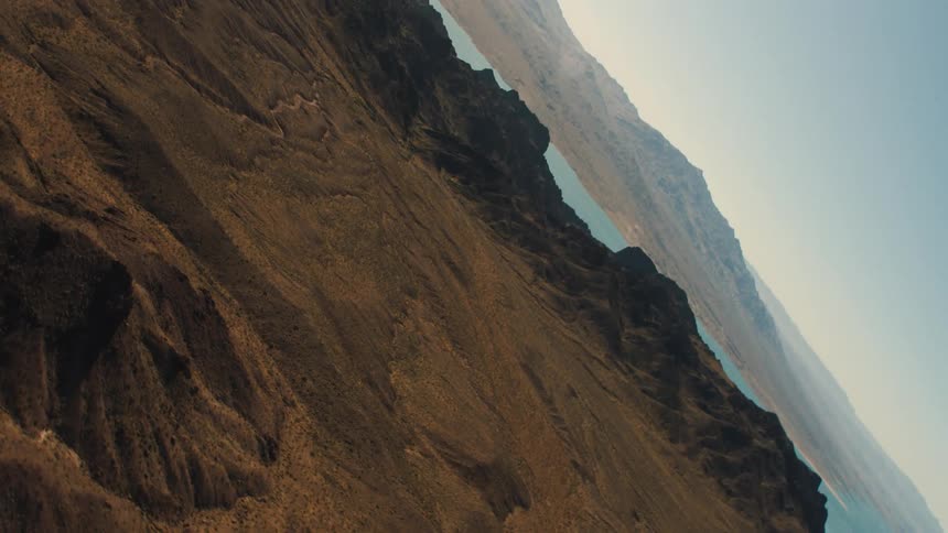 Aerial view of a river near the mountains in the badlands desert