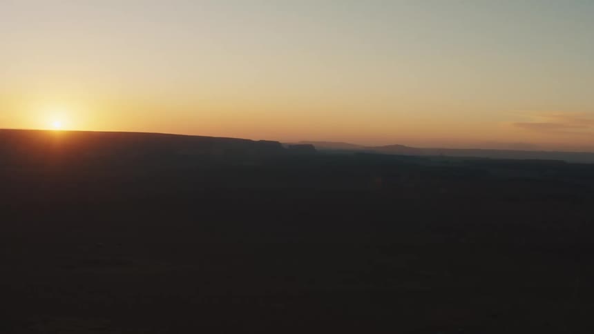 A flat area is dimly lit by the early morning sun