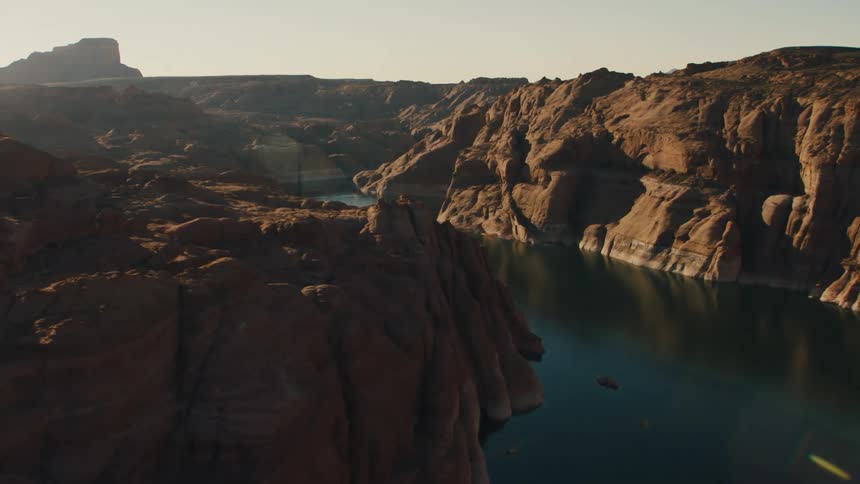 Aerial view of a boat in the water with canyons on both sides