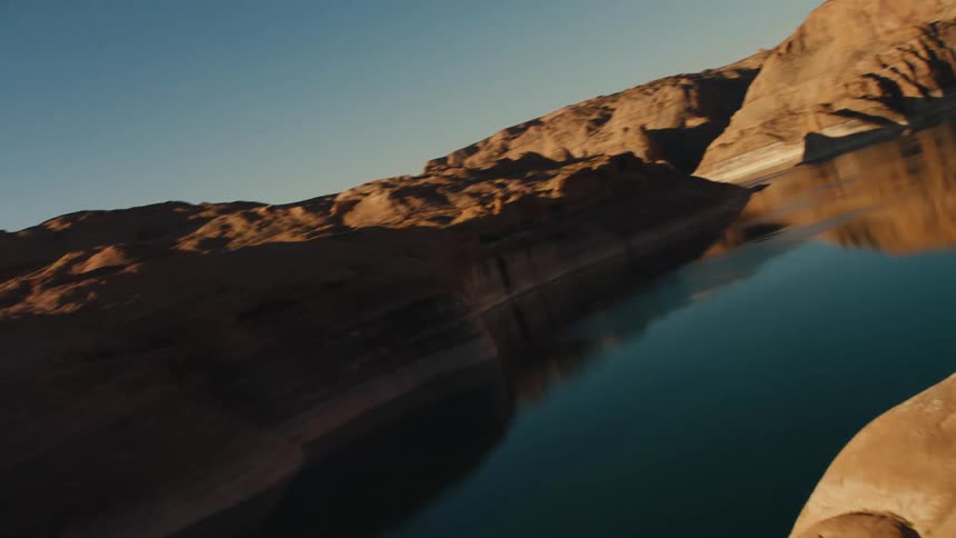 A tranquil lake lies in a rocky area