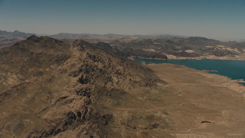 Barren hills line the shores of a body of water