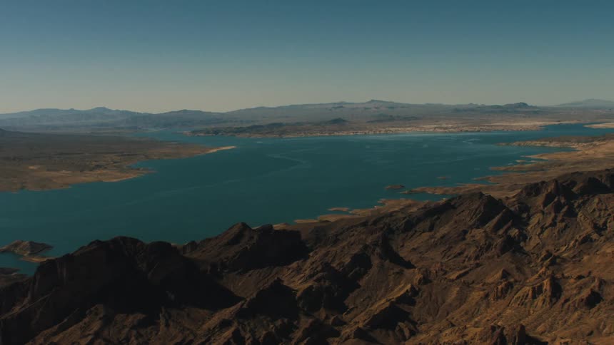 A large lake lies in the middle of jagged hills