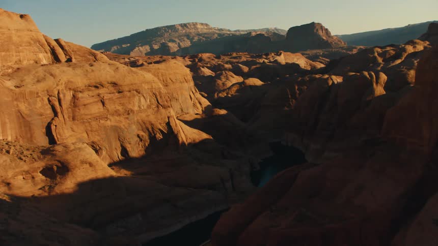 Aerial view of the sun shining down on canyons