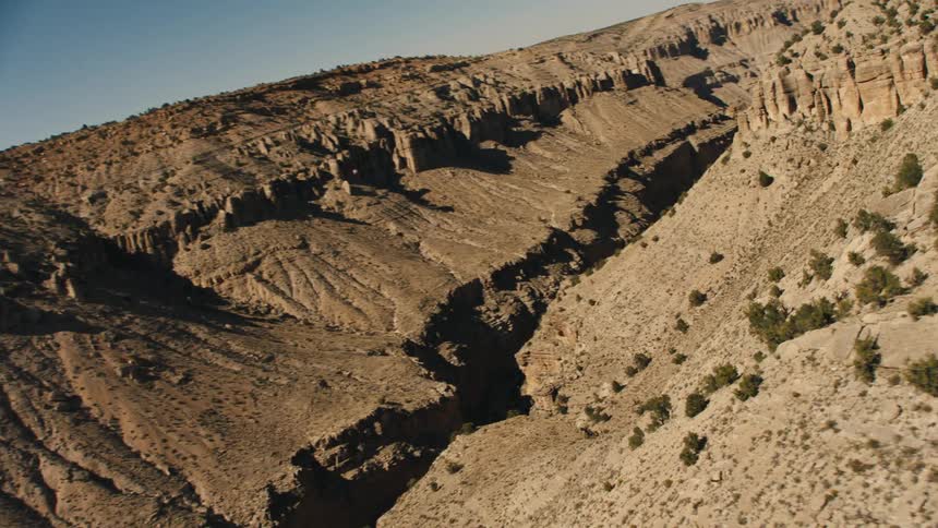 The canyon has many dips and a trail running through the middle